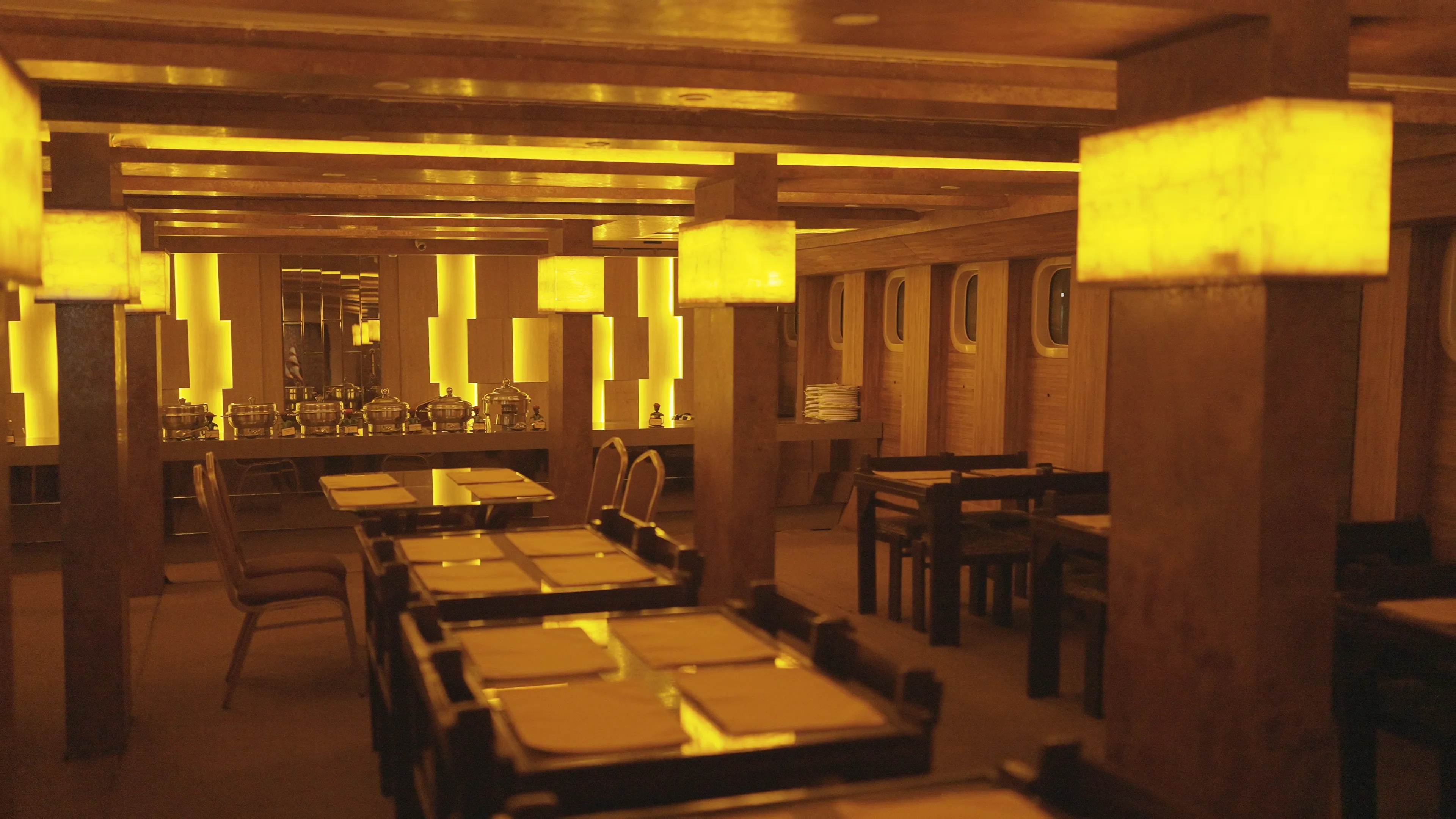 Warm gold-lit interior of the Alfresco Grand dining hall