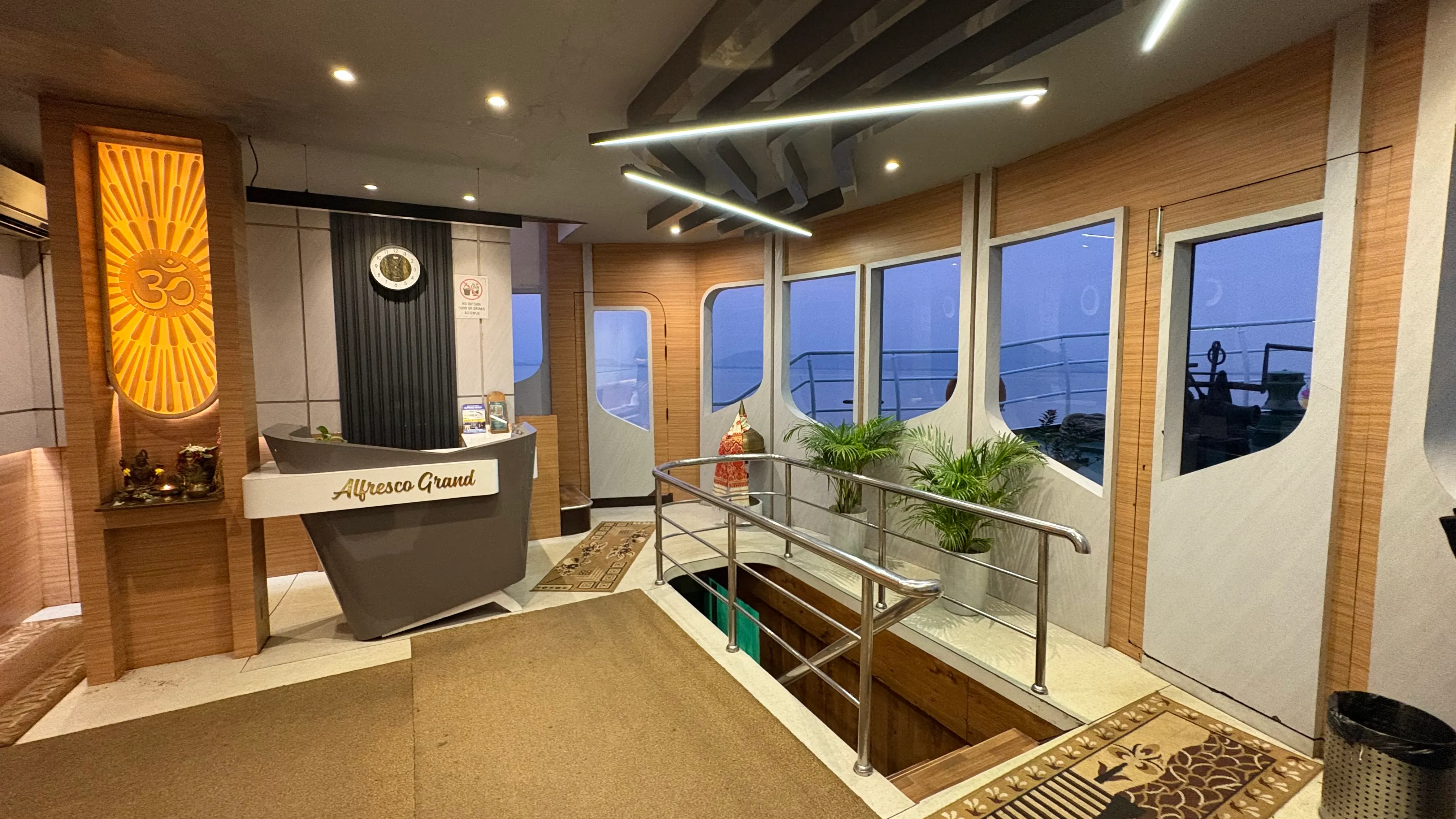 The branded reception desk welcoming guests aboard Alfresco Grand