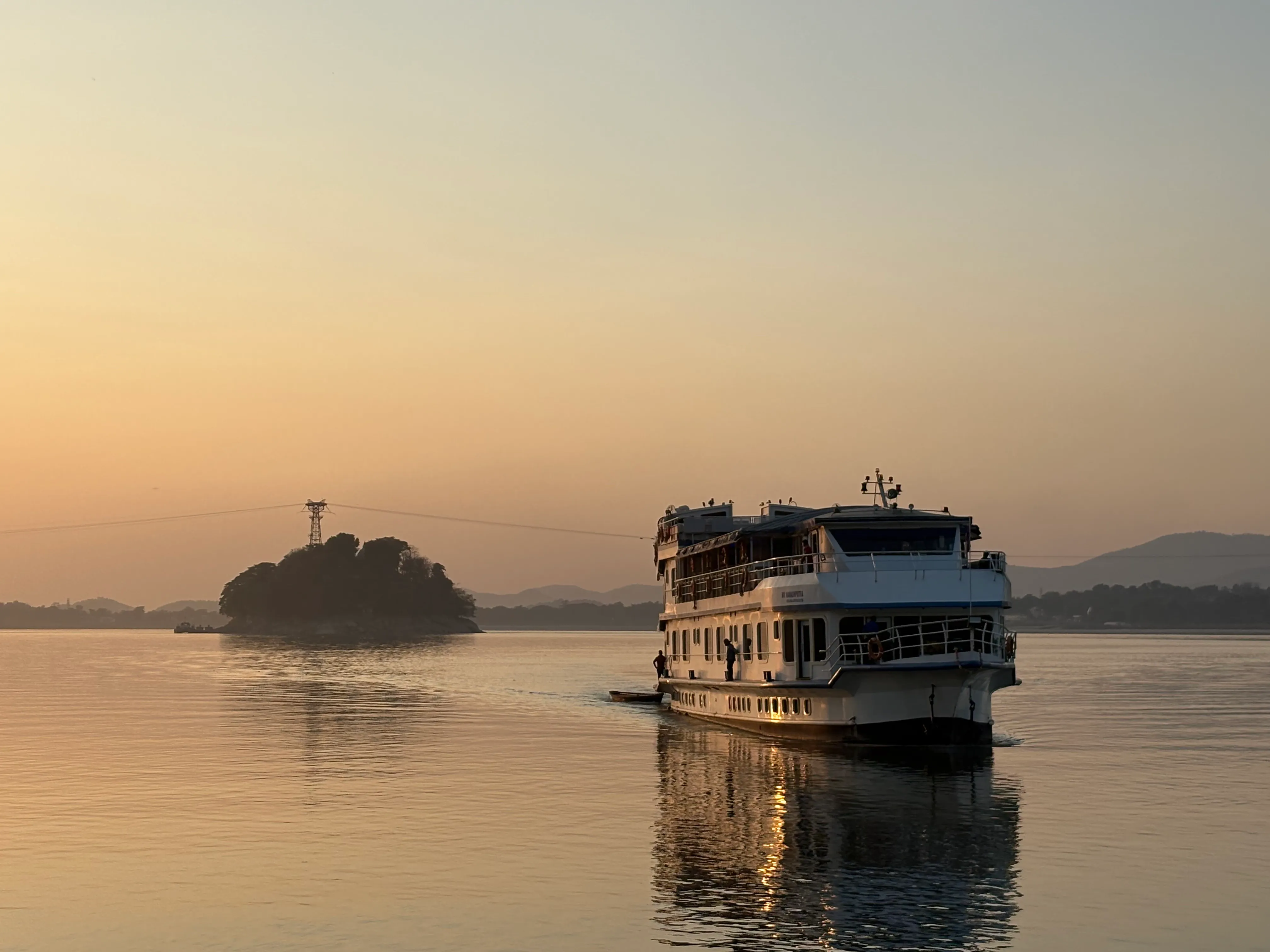 Alfresco Grand cruise vessel on the Brahmaputra under a pink sunset sky