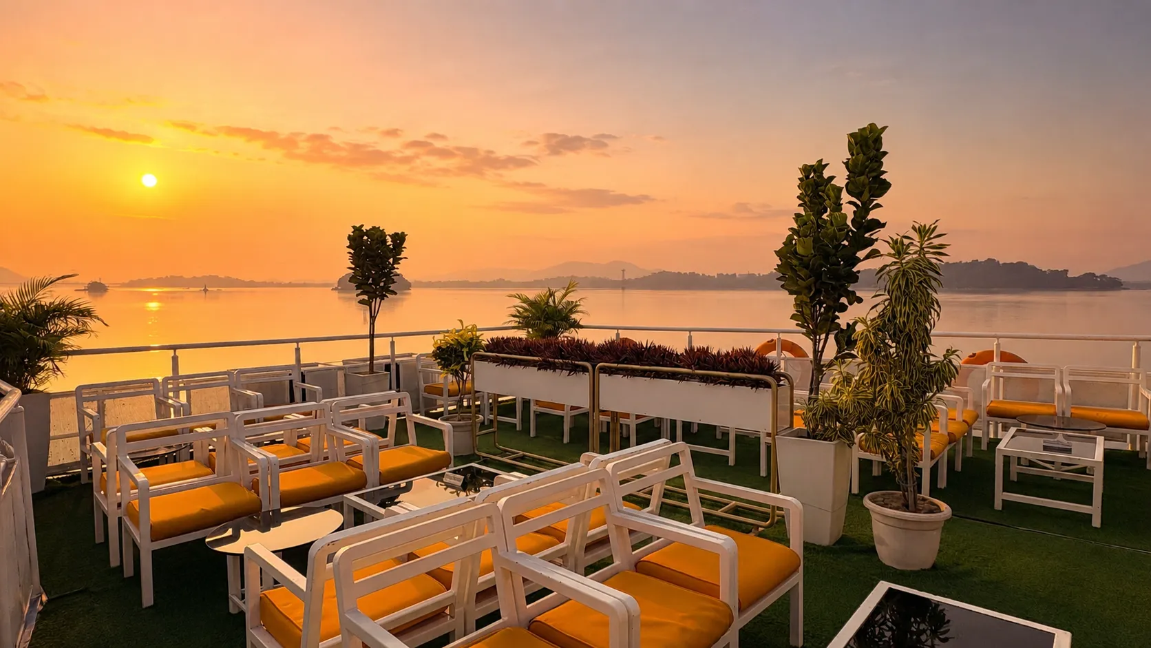 Upper deck of Alfresco Grand in golden-hour light with plants