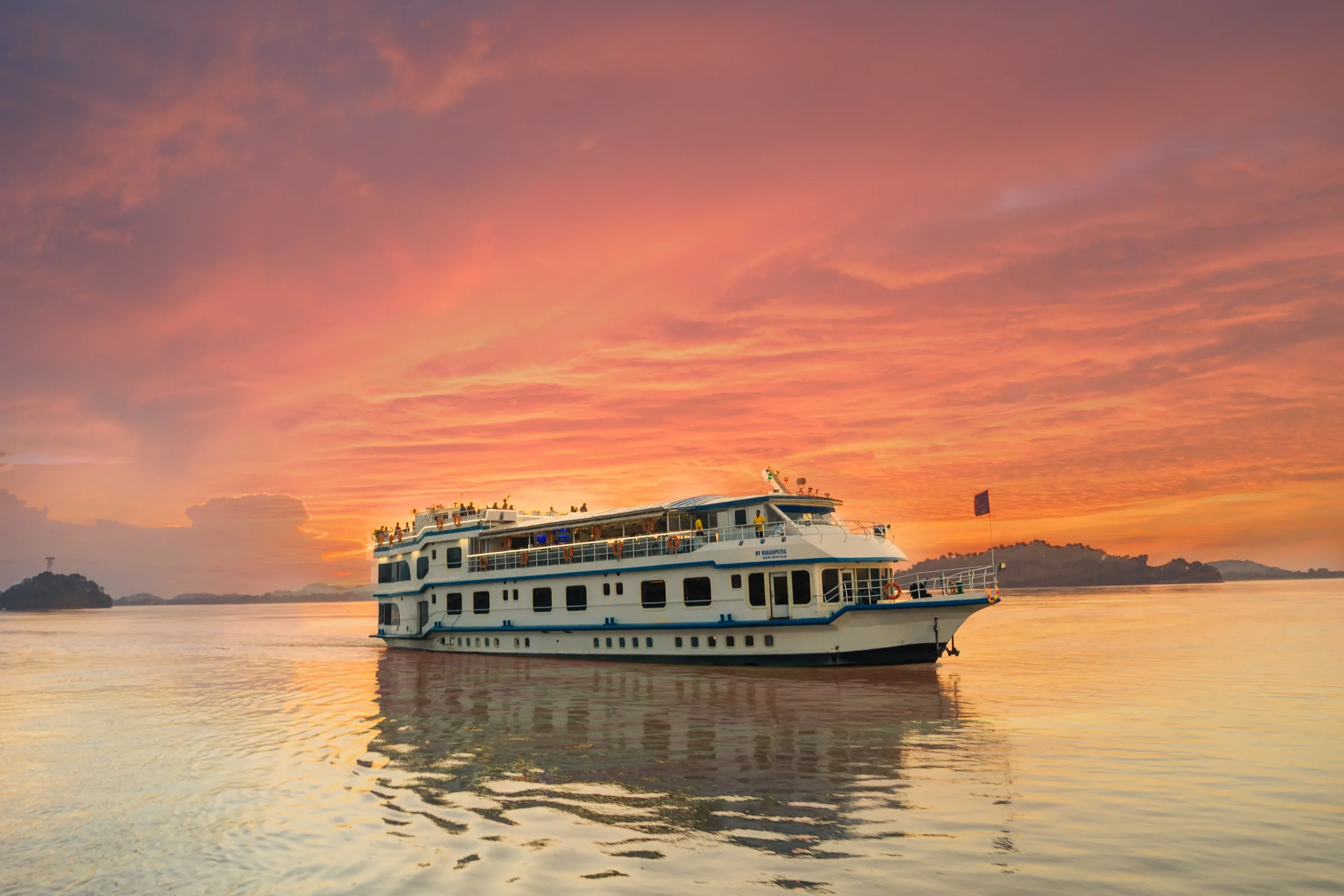 Alfresco Grand on the Brahmaputra under a blazing pink and orange sunset