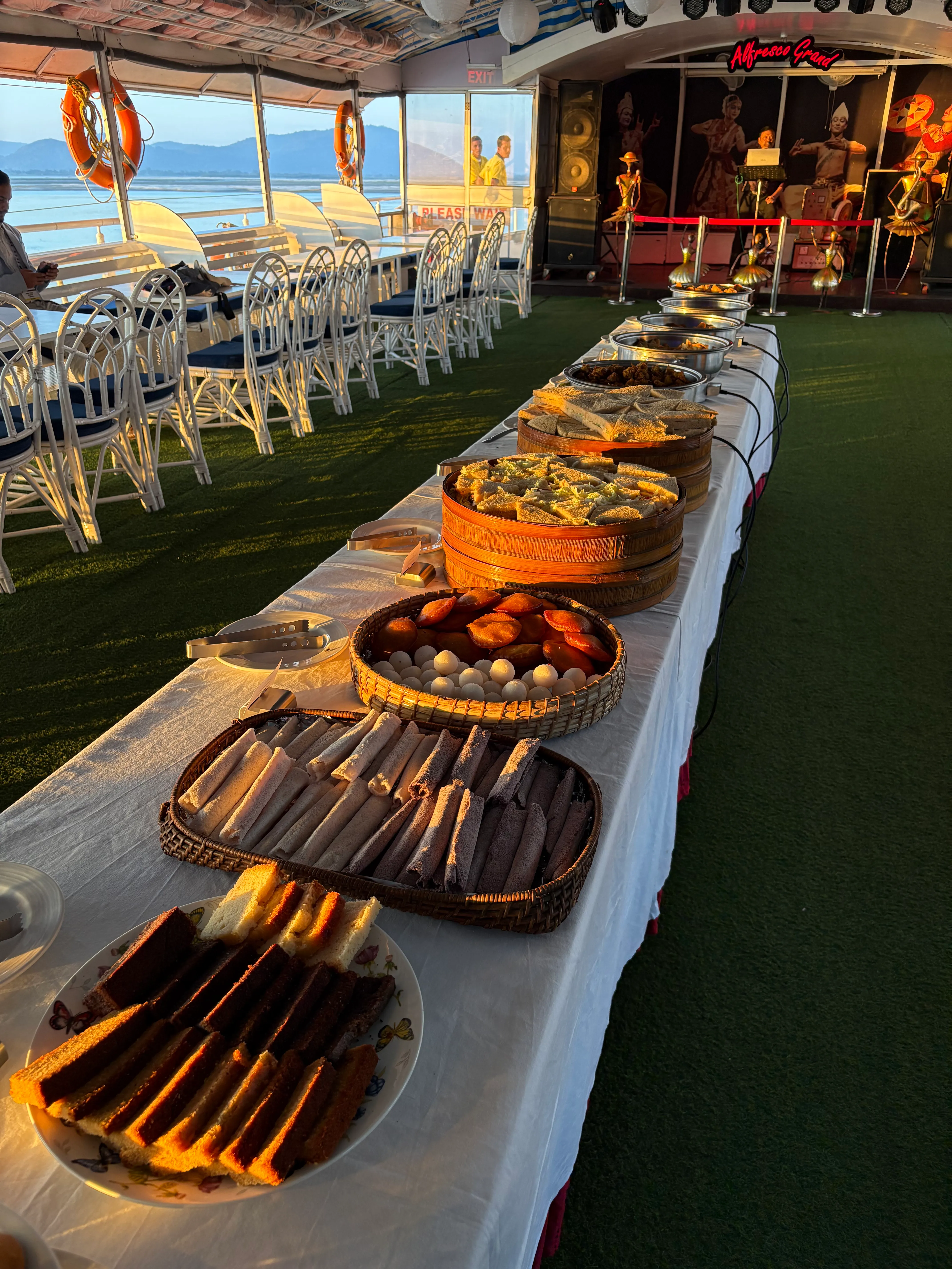 Hi-tea spread served at golden hour on the river cruise