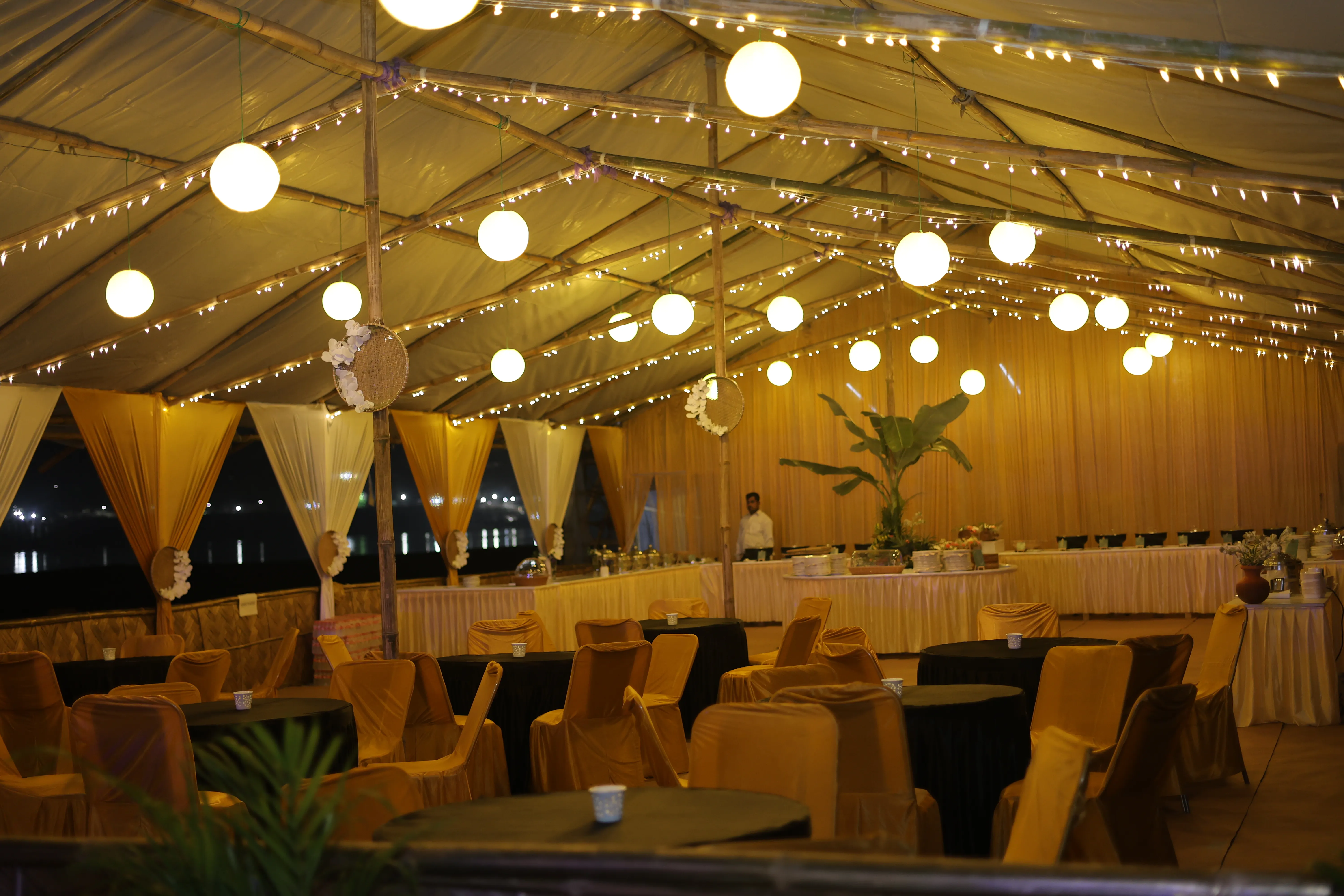 Golden-lit dining hall during a river island event