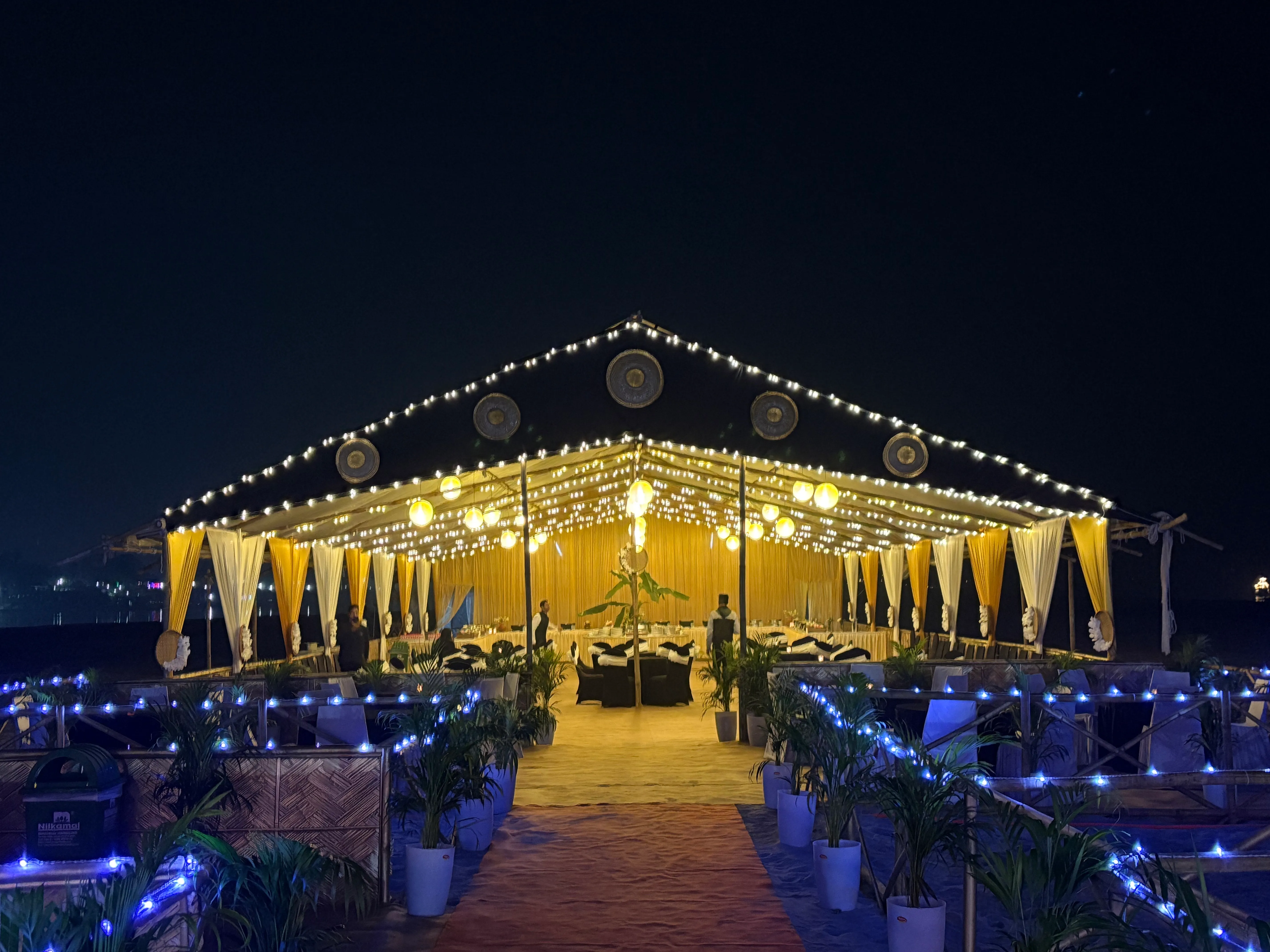 Wedding marquee glowing at night on the river island